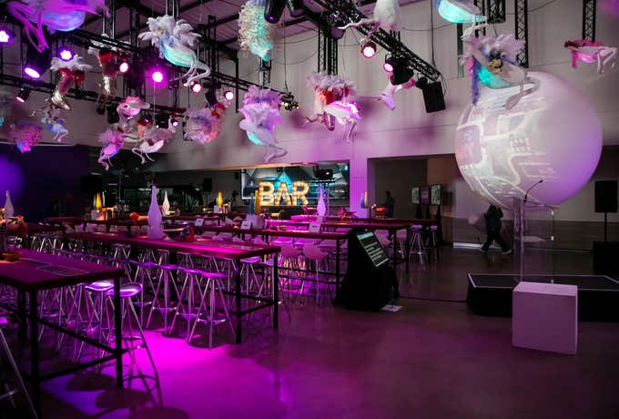Event venue with purple lighting and bar seating